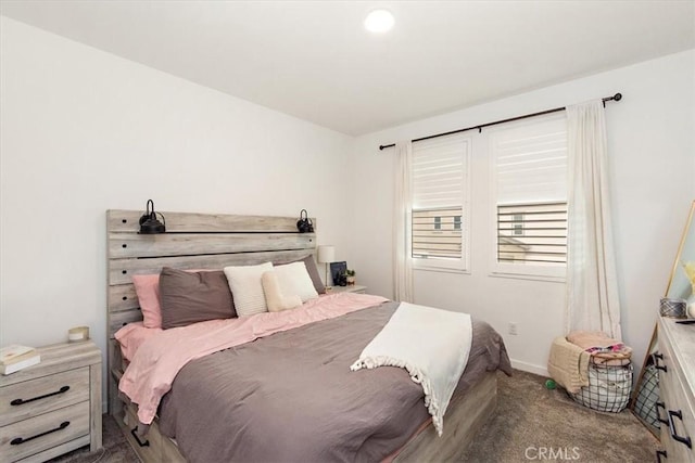 bedroom featuring baseboards and carpet