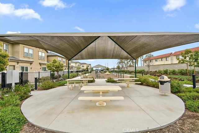 view of home's community featuring fence, a gazebo, and a residential view