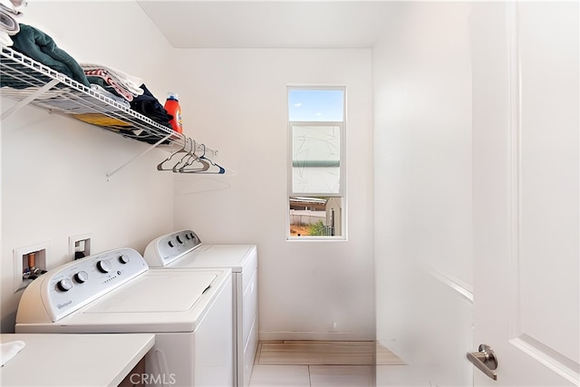 laundry room featuring laundry area, a sink, baseboards, and washing machine and dryer