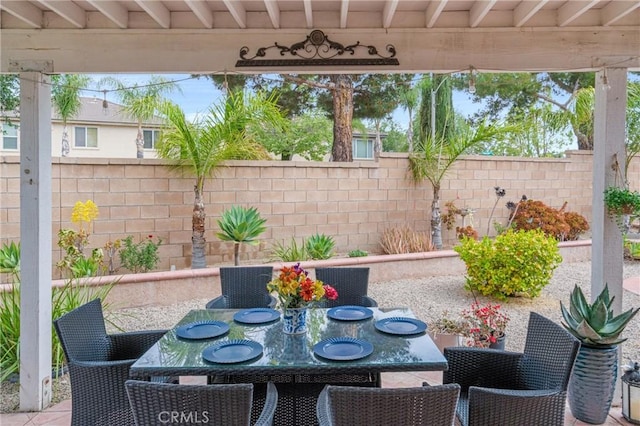 view of patio / terrace featuring fence and outdoor dining space