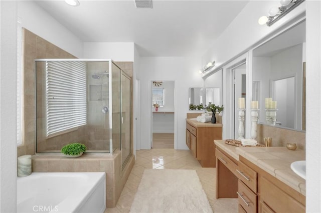 full bath featuring vanity, a bath, tile patterned floors, and a shower stall