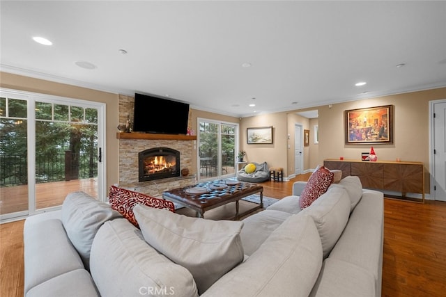 24848 Matterhorn Ct, Crestline, CA 92325 - living area with wood finished floors, recessed lighting, ornamental molding, and a stone fireplace