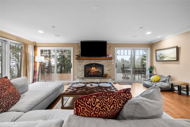 24848 Matterhorn Ct, Crestline, CA 92325 - living room featuring crown molding, a fireplace, wood finished floors, and plenty of natural light
