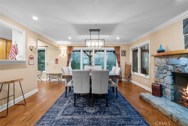 24848 Matterhorn Ct, Crestline, CA 92325 - dining room featuring ornamental molding, a stone fireplace, wood finished floors, and baseboards