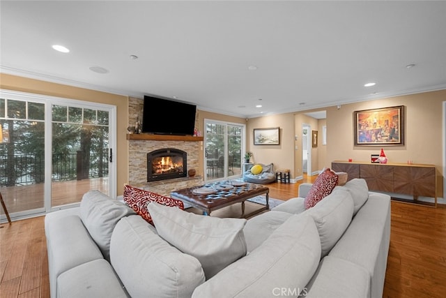 24848 Matterhorn Ct, Crestline, CA 92325 - living room featuring recessed lighting, ornamental molding, a stone fireplace, and wood finished floors