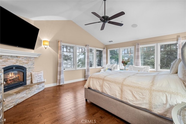 24848 Matterhorn Ct, Crestline, CA 92325 - bedroom featuring wood finished floors, vaulted ceiling, a stone fireplace, baseboards, and visible vents