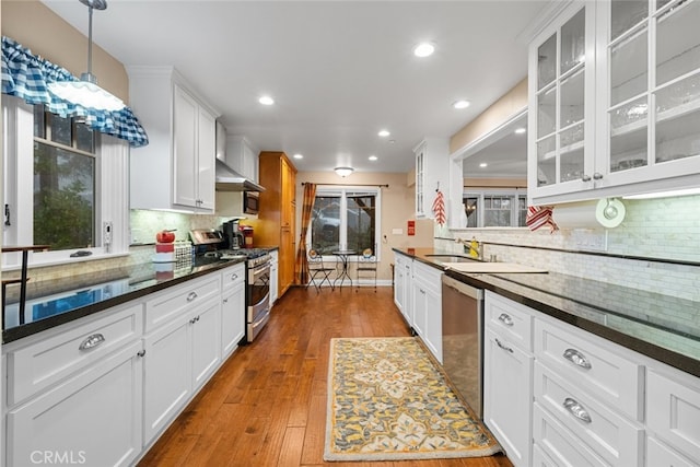 24848 Matterhorn Ct, Crestline, CA 92325 - kitchen featuring white cabinetry, tasteful backsplash, glass insert cabinets, and appliances with stainless steel finishes