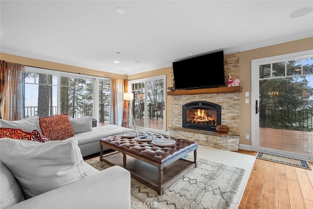 24848 Matterhorn Ct, Crestline, CA 92325 - living room featuring a fireplace, light wood finished floors, ornamental molding, and baseboards