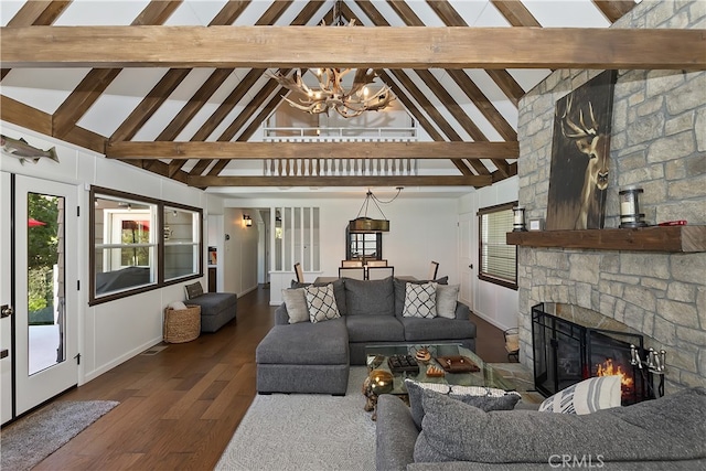 28898 Palisades Dr, Lake Arrowhead, CA 92352 - living room with a chandelier, beamed ceiling, a stone fireplace, high vaulted ceiling, and wood finished floors