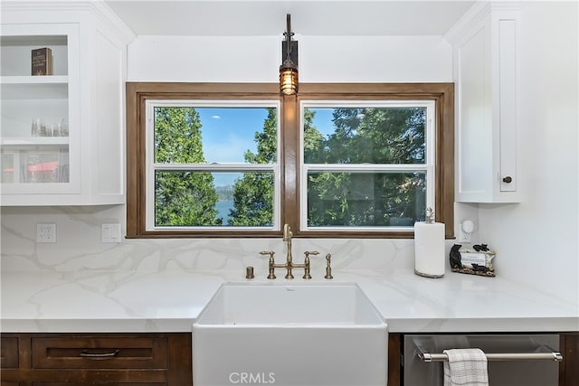 28898 Palisades Dr, Lake Arrowhead, CA 92352 - kitchen with stainless steel dishwasher, white cabinetry, tasteful backsplash, and light stone countertops