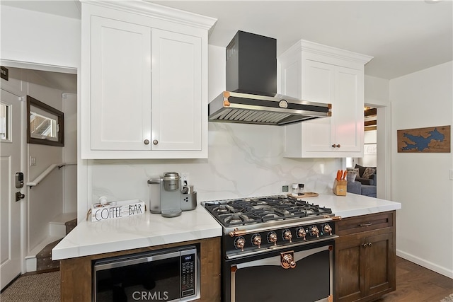 28898 Palisades Dr, Lake Arrowhead, CA 92352 - kitchen with stainless steel appliances, wall chimney exhaust hood, light countertops, and white cabinetry