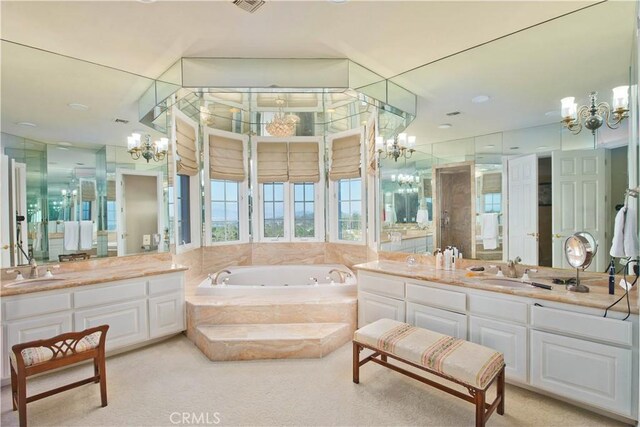 3155 Stone Oak Dr, Los Angeles, CA 90049 - bathroom featuring a sink, a garden tub, and a notable chandelier