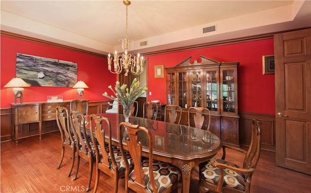 3155 Stone Oak Dr, Los Angeles, CA 90049 - dining room with wood finished floors, visible vents, a notable chandelier, and wainscoting