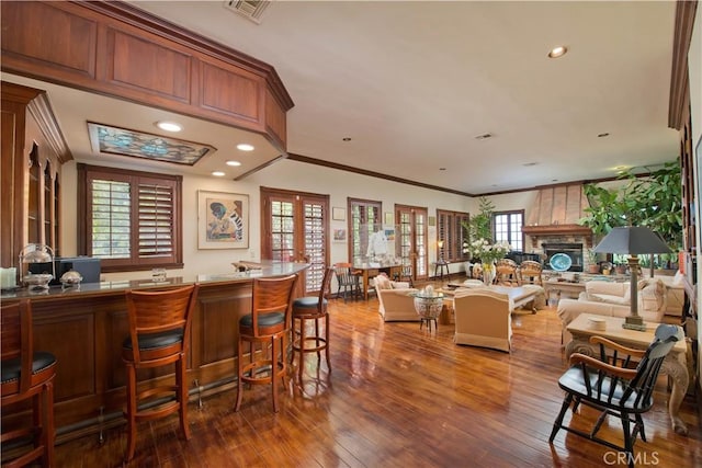 3155 Stone Oak Dr, Los Angeles, CA 90049 - interior space with recessed lighting, a bar, crown molding, visible vents, and hardwood / wood-style floors