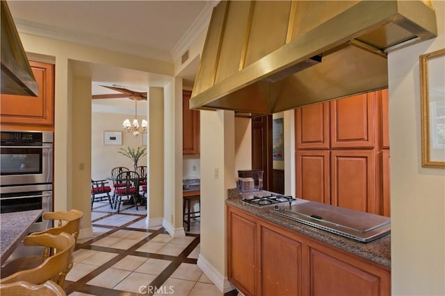 3155 Stone Oak Dr, Los Angeles, CA 90049 - kitchen with appliances with stainless steel finishes, visible vents, an inviting chandelier, light tile patterned flooring, and exhaust hood