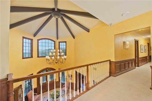 3155 Stone Oak Dr, Los Angeles, CA 90049 - corridor featuring beam ceiling, a notable chandelier, carpet floors, and an upstairs landing