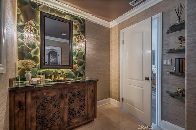 interior space with tile patterned flooring, ornamental molding, vanity, baseboards, and visible vents