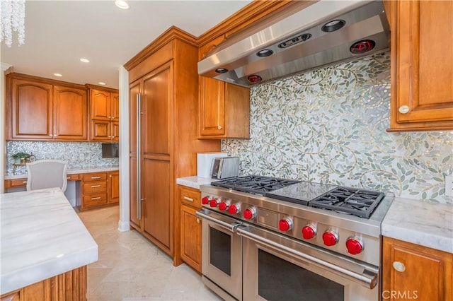 kitchen with brown cabinetry, extractor fan, and double oven range