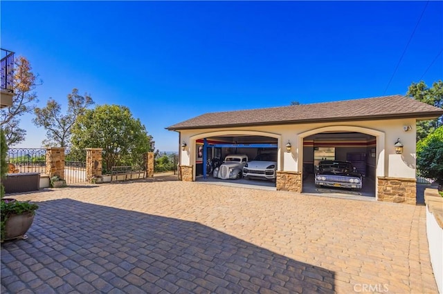 exterior space featuring fence, decorative driveway, and a gate