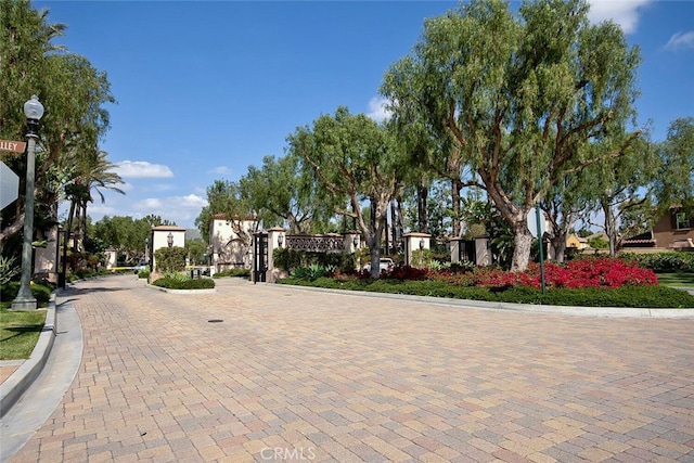 28 Malibu, Irvine, CA 92602 - view of decorative road featuring curbs, street lighting, and a gated entry