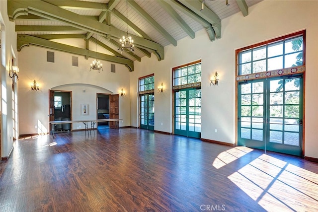 28 Malibu, Irvine, CA 92602 - unfurnished living room with high vaulted ceiling, a chandelier, french doors, wood finished floors, and arched walkways