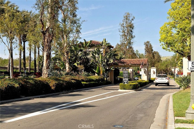 28 Malibu, Irvine, CA 92602 - view of asphalt street featuring curbs and a gated entry