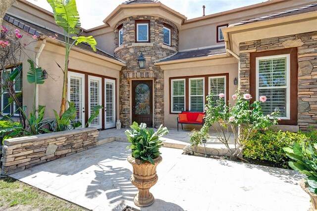 28 Malibu, Irvine, CA 92602 - property entrance featuring stucco siding, stone siding, and a patio
