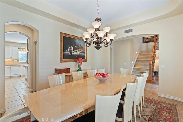 28 Malibu, Irvine, CA 92602 - dining area featuring arched walkways, light tile patterned floors, stairway, and a chandelier