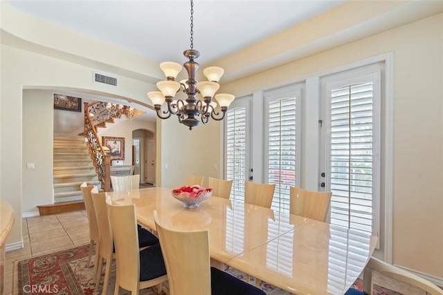 28 Malibu, Irvine, CA 92602 - dining space with arched walkways, stairway, a chandelier, and tile patterned flooring