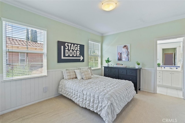 28 Malibu, Irvine, CA 92602 - bedroom featuring light colored carpet, wainscoting, crown molding, and connected bathroom
