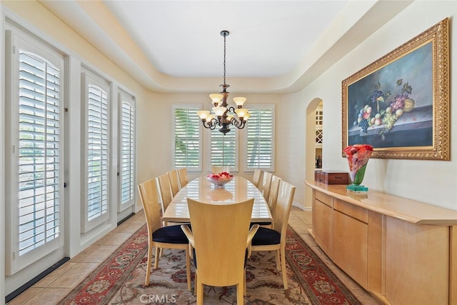 28 Malibu, Irvine, CA 92602 - dining space featuring a chandelier, arched walkways, a raised ceiling, and light tile patterned flooring