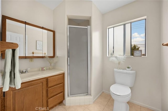 bathroom with tile patterned floors, toilet, vanity, baseboards, and a stall shower