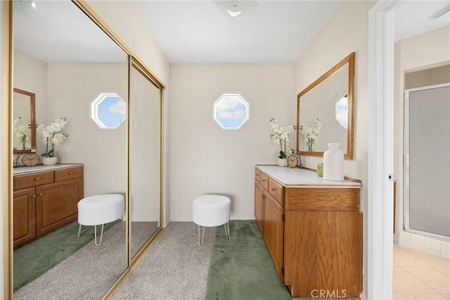 full bath with a shower stall and vanity