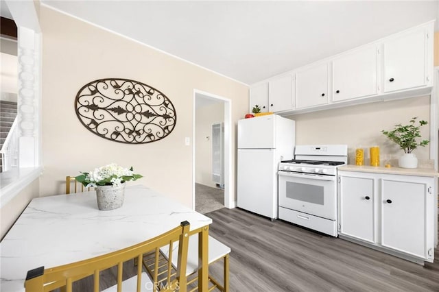 kitchen with dark wood-style flooring, white cabinetry, white appliances, and light countertops