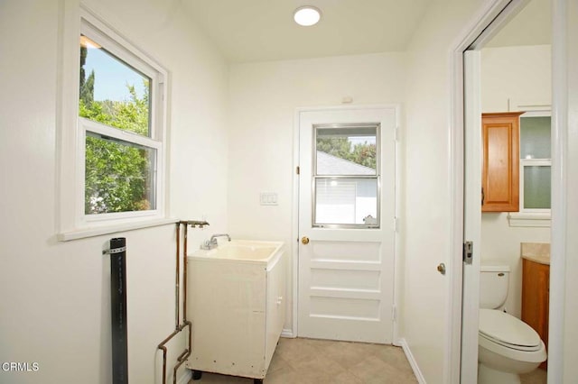 bathroom featuring toilet, tile patterned floors, and vanity