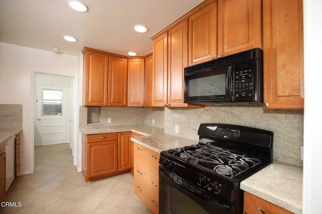 kitchen with tasteful backsplash, black appliances, recessed lighting, and brown cabinets