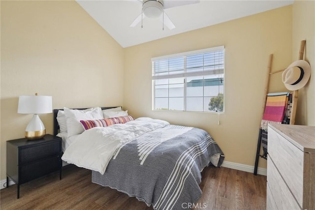 bedroom featuring ceiling fan, vaulted ceiling, wood finished floors, and baseboards