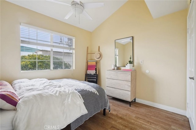 bedroom with baseboards, wood finished floors, a ceiling fan, and vaulted ceiling