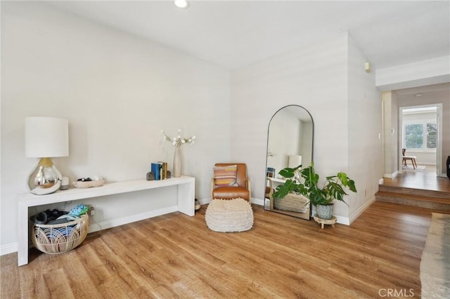 living area with baseboards, recessed lighting, and wood finished floors