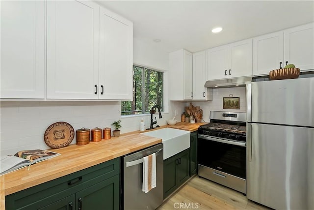 377 Hillside Rd, Lake Arrowhead, CA 92352 - kitchen featuring appliances with stainless steel finishes, green cabinetry, wood counters, white cabinetry, and backsplash
