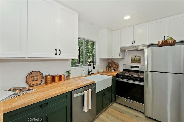 377 Hillside Rd, Lake Arrowhead, CA 92352 - kitchen featuring stainless steel appliances, green cabinetry, wood counters, white cabinetry, and decorative backsplash