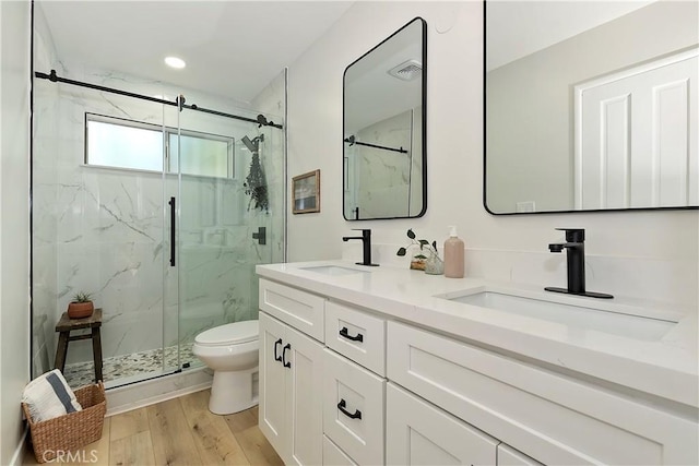 377 Hillside Rd, Lake Arrowhead, CA 92352 - full bath with a marble finish shower, double vanity, wood finished floors, and recessed lighting