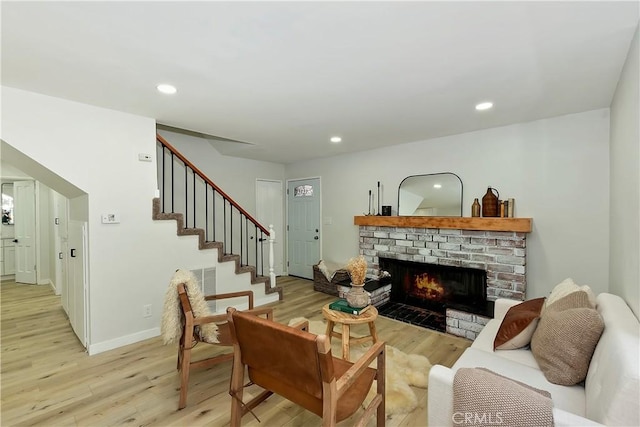 377 Hillside Rd, Lake Arrowhead, CA 92352 - living room with light wood-style flooring, a brick fireplace, stairs, recessed lighting, and baseboards
