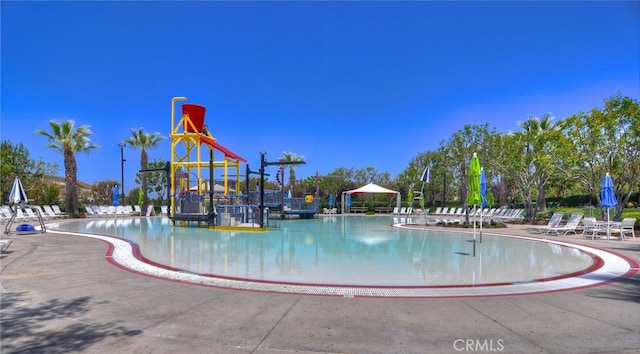 exterior space featuring a water play area and a community pool