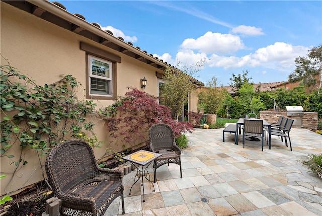 view of patio / terrace featuring area for grilling, exterior kitchen, and outdoor dining space