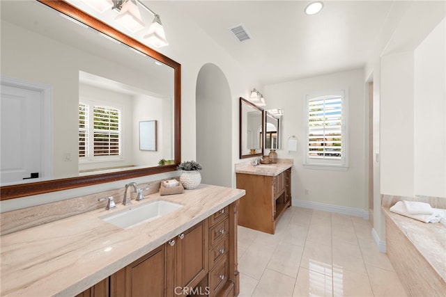 bathroom with a sink, tile patterned floors, two vanities, and visible vents