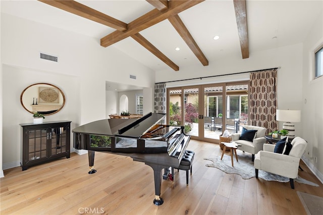 sitting room with wood-type flooring, baseboards, a wealth of natural light, and beam ceiling