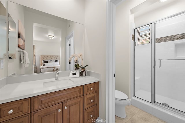 bathroom featuring vanity, toilet, ensuite bathroom, tile patterned floors, and a shower stall