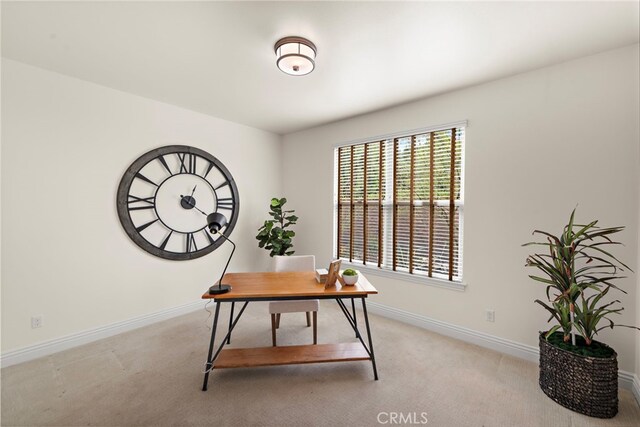 office with light colored carpet and baseboards
