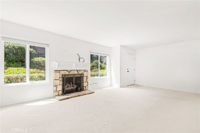 unfurnished living room with carpet and a fireplace